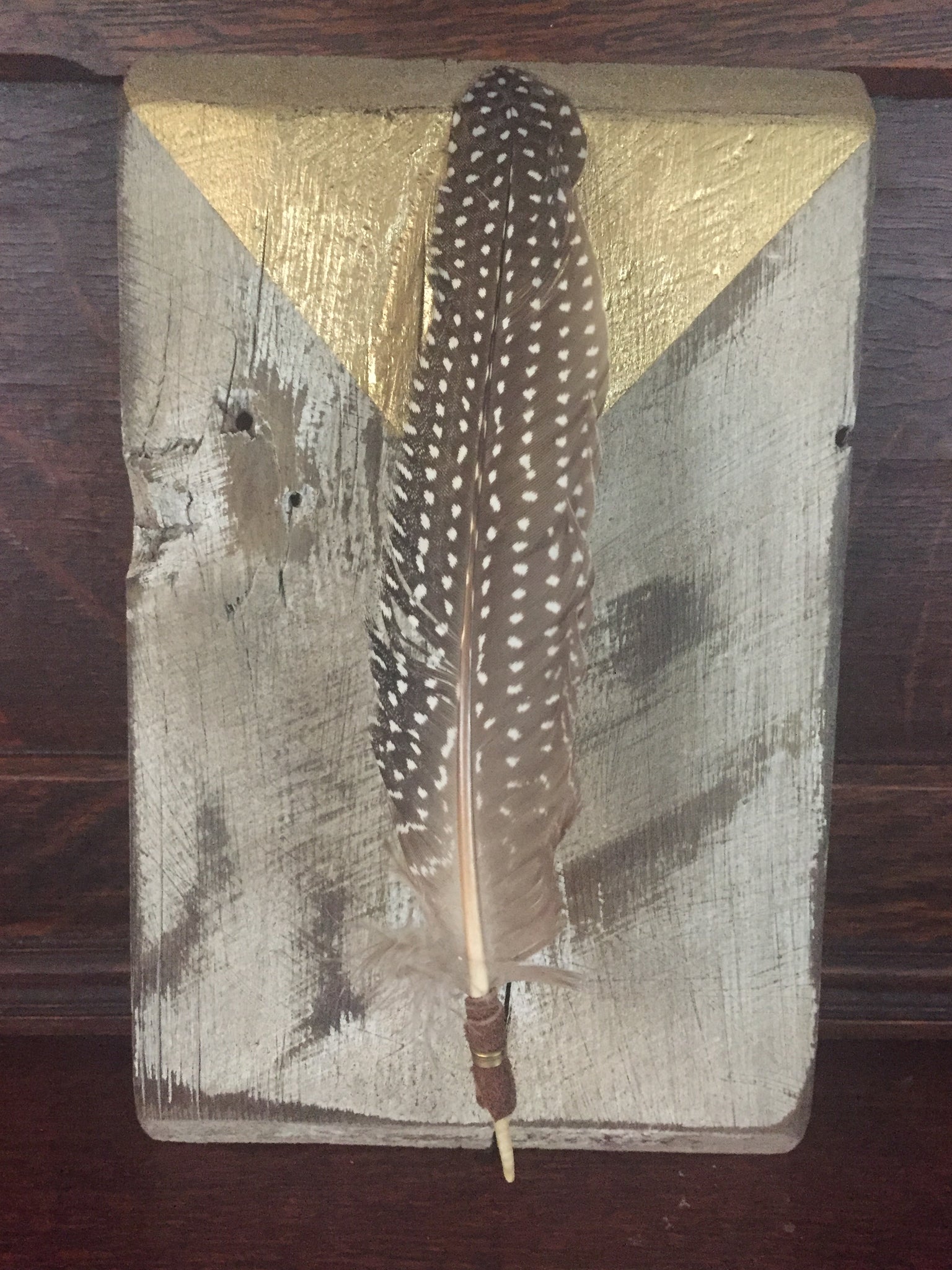 Floating Feather on Reclaimed Wood